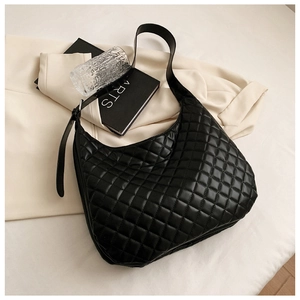 Detail of black quilted hobo bag with adjustable strap and classic textured finish
