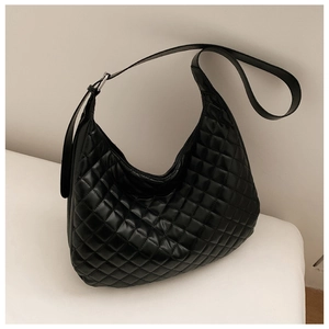 Detail of the black quilted texture and silver buckle on the adjustable leather strap