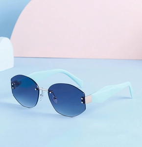 Detail view of rimless sunglasses with blue gradient lenses and geometric mint temples
