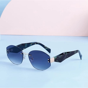 Detail of rimless polygon sunglasses with blue gradient lenses and marble textured temples