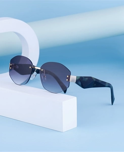 Macro detail of rimless sunglasses with purple gradient lenses and marble patterned arms