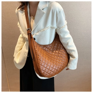 Detail view of brown quilted hobo bag in soft PU leather with adjustable shoulder strap