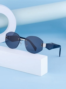 Detailed macro view of rimless octagonal blue lenses and sculptural blue geometric temples