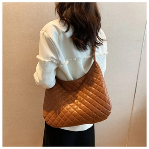 Detailed back view of a brown quilted tote bag with a spacious diamond pattern design
