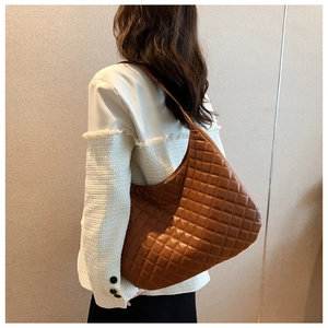 Detail of a brown quilted hobo bag featuring premium diamond stitching and large capacity