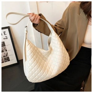Detail shot of beige quilted rhombic texture on a spacious hobo shoulder bag for women
