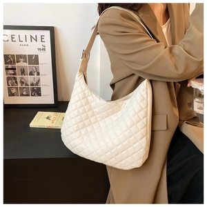 Detail of off-white quilted hobo bag featuring elegant rhombic patterns and soft leather texture