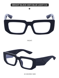 Detail view of glossy black wide-temple glasses with 3D geometric texture and blue light lens