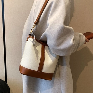 Minimalist white and caramel patchwork bucket bag for women stylish commuting style
