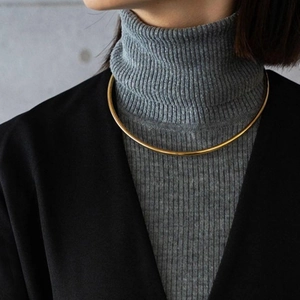 Minimalist golden polished rigid choker necklace shown on a model for modern styling