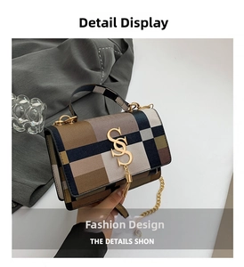 Macro detail of plaid crossbody bag with golden logo, metal tassel and chain strap