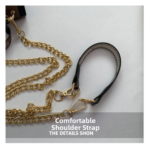 Detail of multi-ring gold metal chain with black and white shoulder strap and lobster clasps