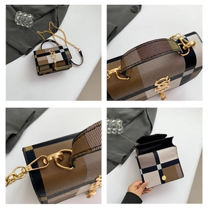 Detail view of mini plaid bag showing golden SS logo, tassel, and inner compartments