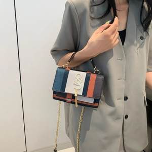 Rainbow striped crossbody bag with gold chain strap and luxury tassel detail