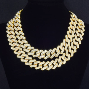 Close-up of triple-row gold Cuban link necklace encrusted with white rhinestones