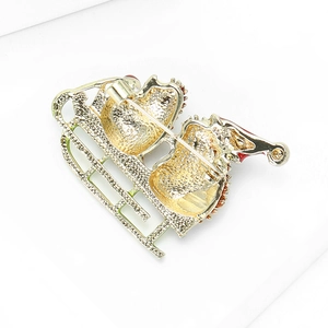 Golden Santa sleigh brooch back view showing secure pin clasp and metal texture