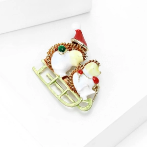 Detail of Christmas hedgehog brooch with enamel finish and colorful festive accents