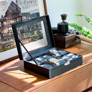 Detail of 10-slot black PU leather watch box with transparent lid and velvet interior