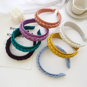Detailed view of woven braided headbands in seven elegant matte colors set for women