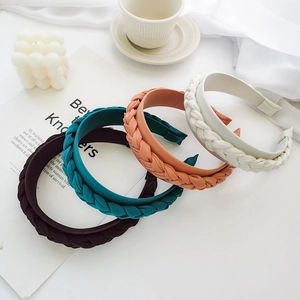 Detailed close-up of colorful braided satin headbands in French vintage style