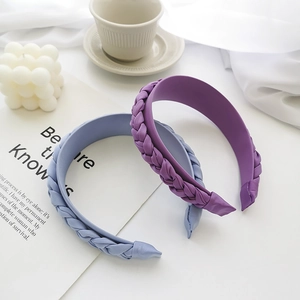 Detailed view of woven twisted headband in light blue and purple with fabric texture