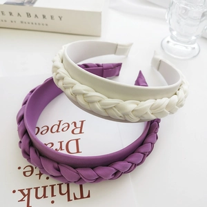 Detail of purple and beige braided thick headbands with rich woven texture