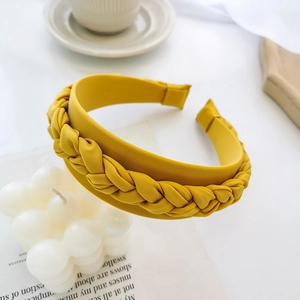 Detail of yellow braided headband showing high-quality satin fabric and woven texture