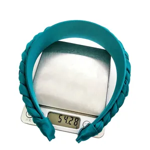 Braided peacock blue fabric headband for women weighing 54g on a digital scale