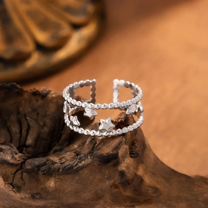 Minimalist silver-tone hollow star double-layer open ring on rustic wood background