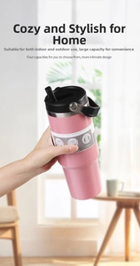 Pink 30oz tumbler with ergonomic handle held in hand featuring a matte finish and straw