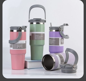Detail showing 30oz vacuum insulated mugs in pink, green, and purple with handle lids