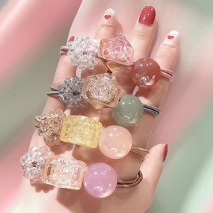 Pastel crystal beads on elastic hair bands worn on fingers for a cute Korean style look