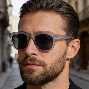Close-up of men wearing retro square matte gray sunglasses with gold rivet accents