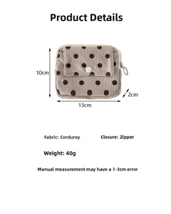 Detailed view of corduroy polka dot wallet with zipper and snap button closure