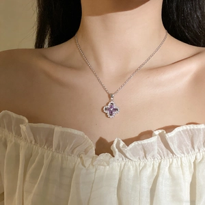 Titanium steel four-leaf clover necklace with purple stones worn by a model