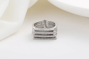 Macro detail of multi-layer silver ring with S925 hallmark and sparkling zircon micro-pave