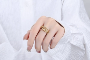Detailed macro view of gold multi-layered zircon ring with woven texture and spinning beads