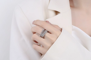 Detail of multi-layer silver ring with sparkling micro-pave zircons worn on finger