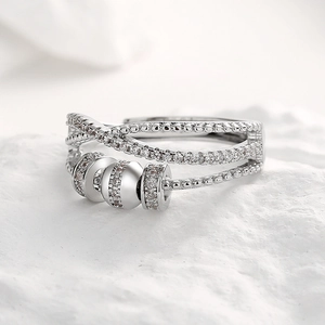 Silver multilayer zircon spinning ring with revolving beads on a white stone base