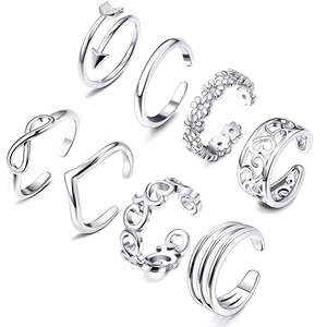 Macro detail of 8 silver bohemian toe rings featuring vintage carved patterns and symbols