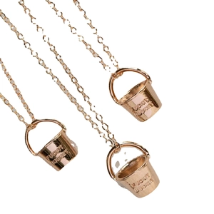 Three trendy bucket-shaped pendant necklaces in rose gold finish with unique engravings