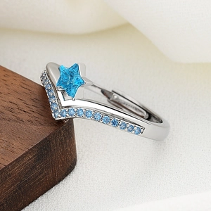 Star-shaped blue crystal open ring with V-shaped silver band and accent stones