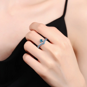 Minimalist silver star ring set with blue gemstones and V-shaped pavé band