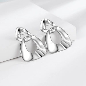 Minimalist silver-tone geometric earrings with wavy textured metallic finish for women