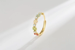 Detail of gold open ring with colorful enamel flowers and sparkling cubic zirconia stones