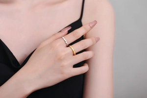 Detailed view of interconnected heart-shaped ring bands in gold and silver plating