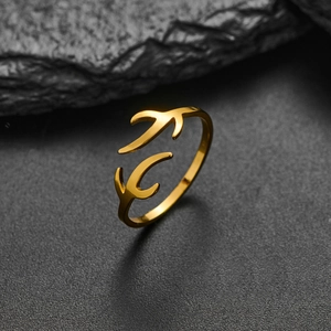 Minimalist gold reindeer antler open adjustable ring on textured black stone