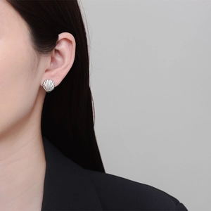 Minimalist 18k silver shell stud earring with fan shape stripes on a female model