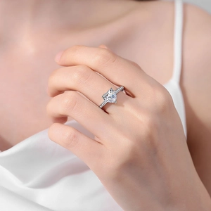Elegant silver engagement ring with heart-shaped pink zircon and micro-pave side stones