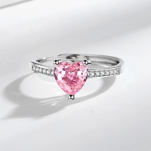 Fashionable silver ring with a large pink heart-shaped crystal and zircon side stones